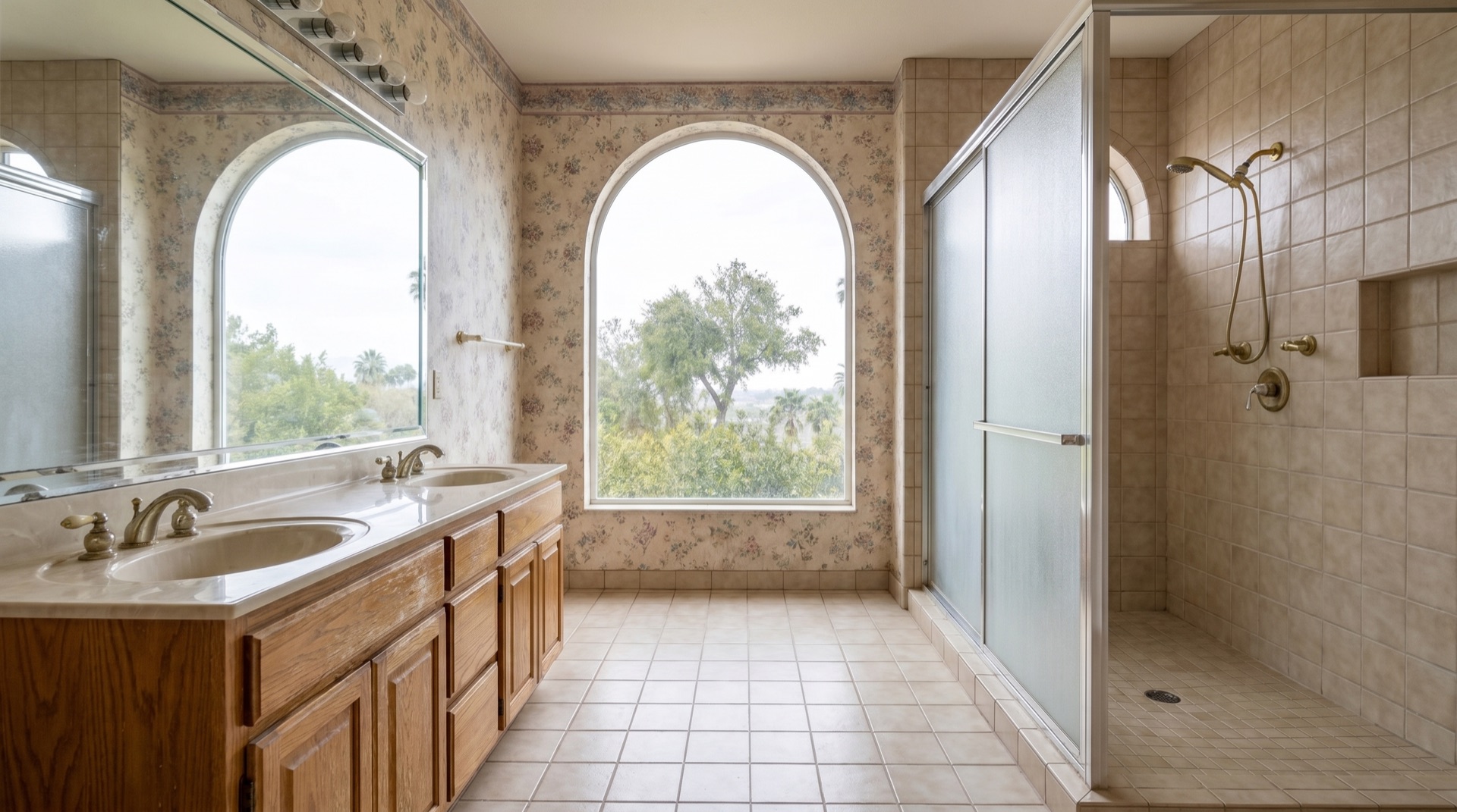 Dated 1990s primary bathroom before remodel — beige tile and builder-grade fixtures